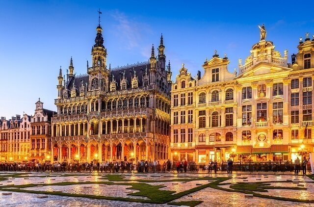 Brussels, Belgium. Wide angle night scene of the Grand Place and Maison du Roi, one of Europe finest historic squares and a must-see sight of Bruxelles.